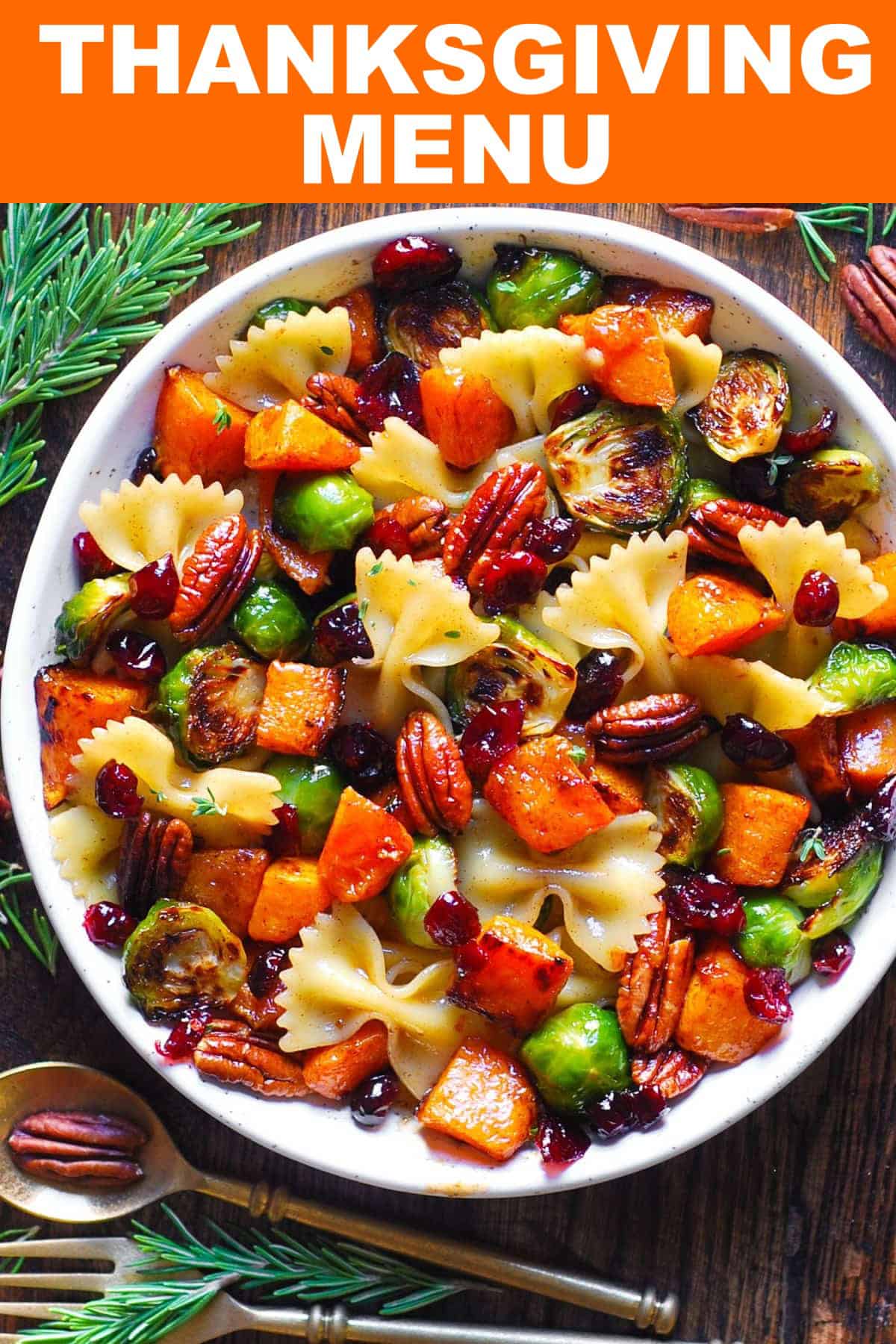 Thanksgiving Menu Pasta Salad with Roasted Butternut Squash, Brussels sprouts, pecans, and cranberries - in a white bowl.