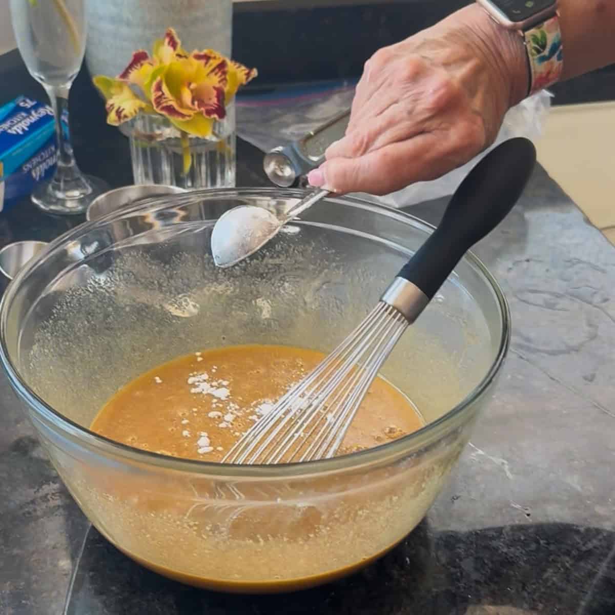 How to make pecan pie filling Making pecan pie filling in a bowl.