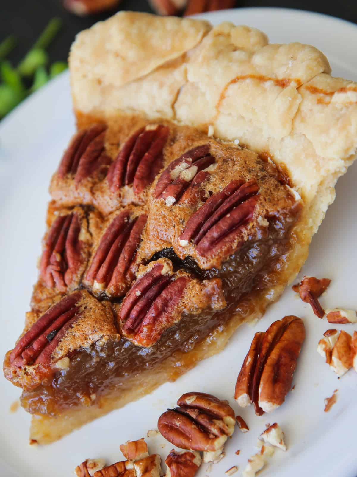 Classic Homemade Pecan Pie A slice of Pecan Pie on a white plate.