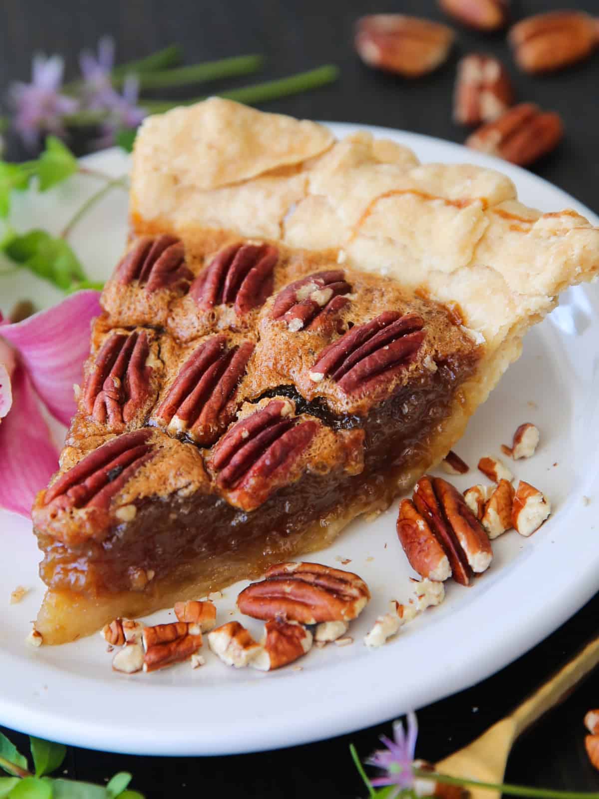 Classic Homemade Pecan Pie A slice of Pecan Pie on a white plate.