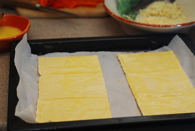 egg wash for Puff pastry pizzas with mushrooms, bell peppers, Mozzarella and Parmesan cheese