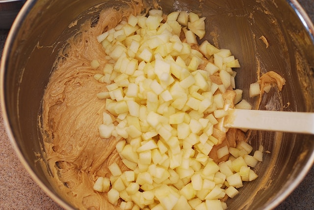 mixing apples in the dough 