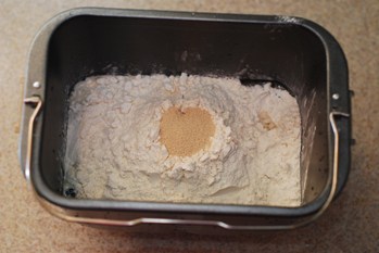 Adding dry yeast to dry ingredient in bread pan