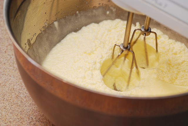 Mixing eggs, sugar, soften butter, and sour cream