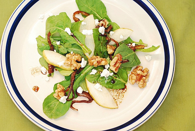 Arugula salad with caramelized onions, walnuts, pears, and Gorgonzola cheese