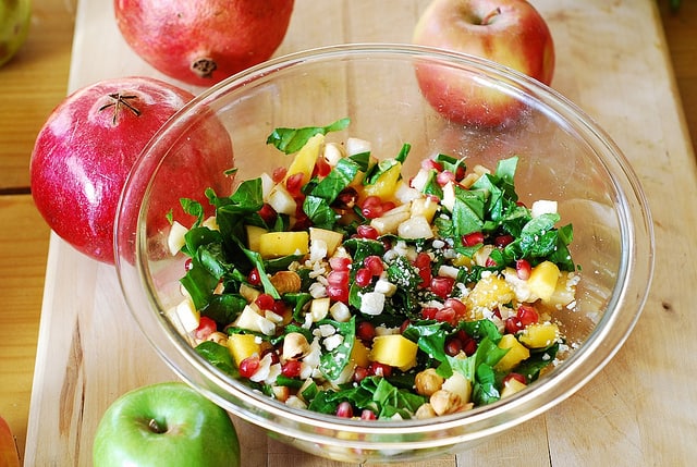 Chopped salad with fruit, pomegranates, nuts, and Gorgonzola cheese