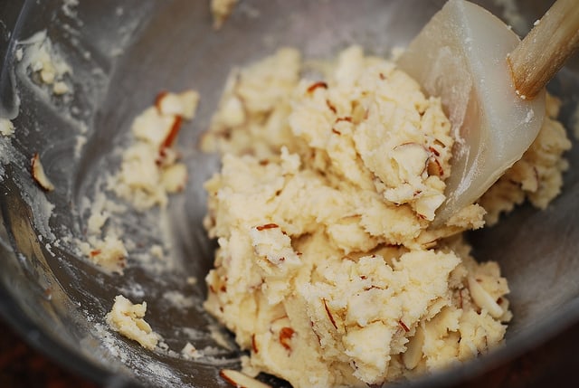 mixing in sliced almonds into the cookie dough