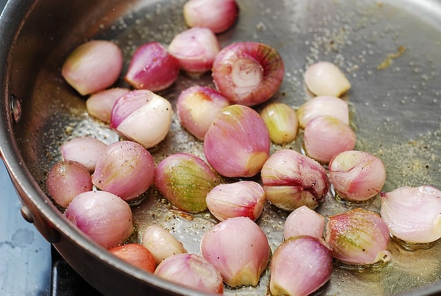 small onions in a pan, shallots