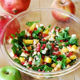 chopped salad with spinach, apples, pears, pomegranate seeds
