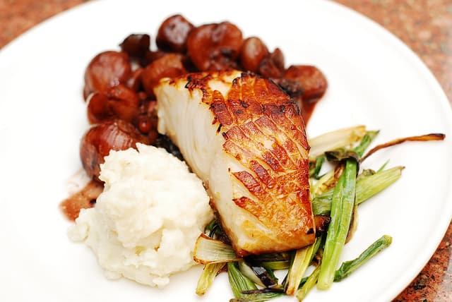 Black cod with balsamic and caramelized shallot sauce and mashed potatoes, roasted green onions, fish