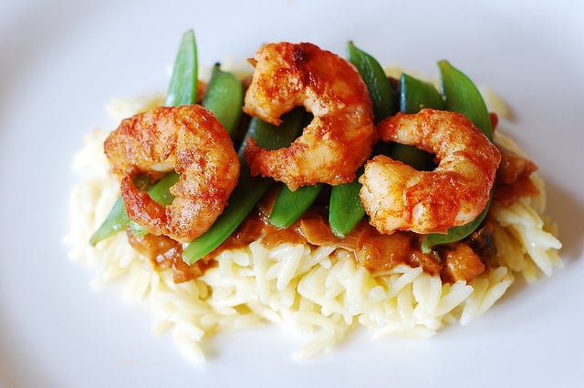 Spicy curry shrimp pasta: curried tomato sauce, snap peas, orzo rice