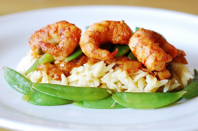 Spicy curry shrimp pasta: curried tomato sauce, snap peas, orzo rice