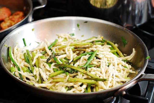 cooking pasta and adding asparagus