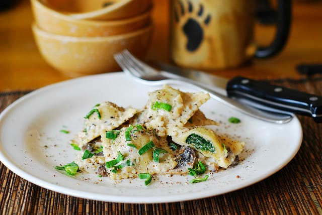 Ravioli with goat cheese and spinach filling in parmesan cream sauce