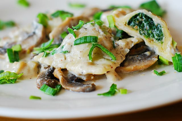 Ravioli with goat cheese and spinach filling in parmesan cream sauce