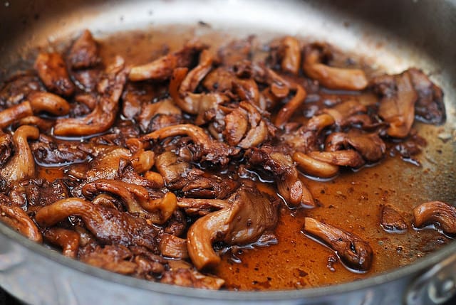 add red wine to cooked mushrooms in a large skillet