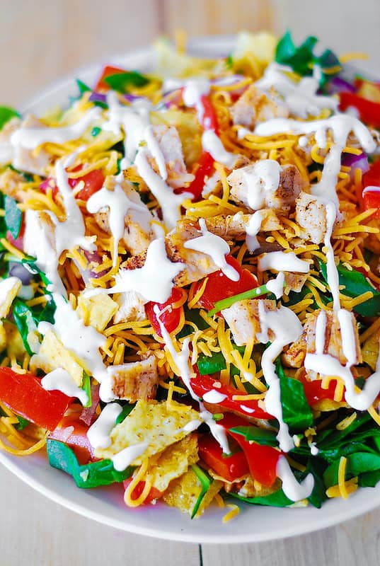 Chicken Taco Salad with Spinach, Tomatoes, Bell Pepper, Tortilla Chips, and Cheddar Cheese