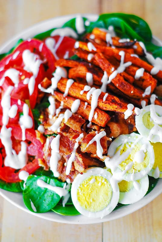 Sweet potato fries, spinach, bacon, eggs, tomato salad with mayo-based dressing