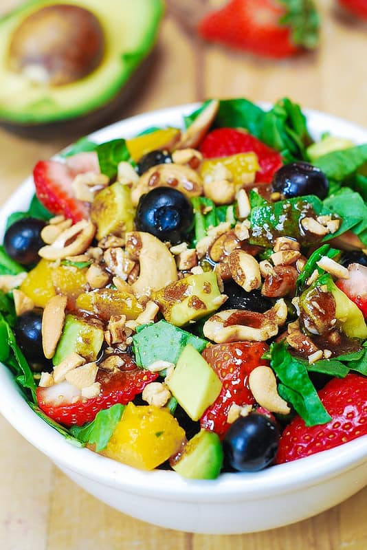 Strawberry Spinach Salad with Mango, Avocado, Blueberries, and Cashew Nuts, tossed with a simple homemade balsamic vinaigrette