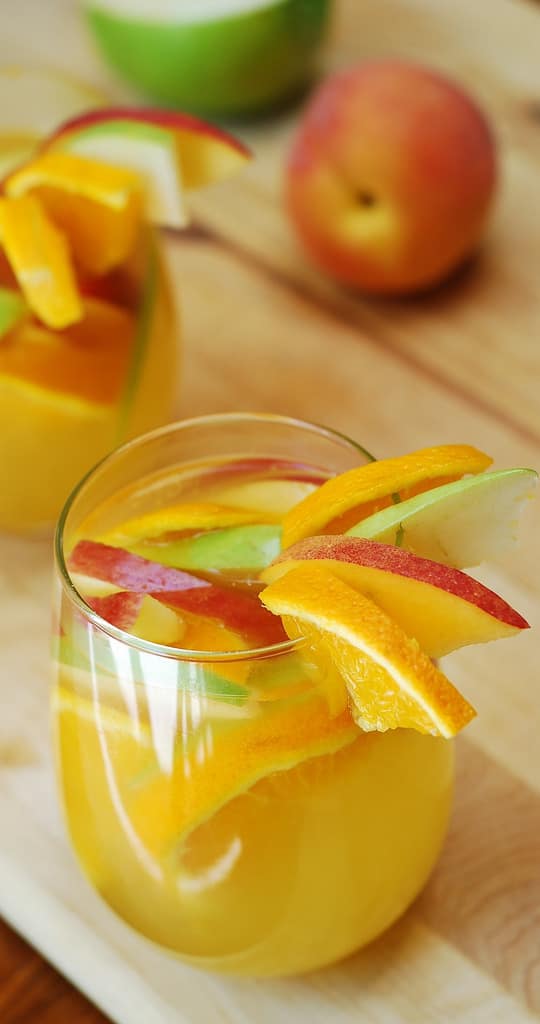 White sangria with dry white wine, Peach Schnapps, brandy, orange juice and lots of fruit, such as peaches, apples, oranges