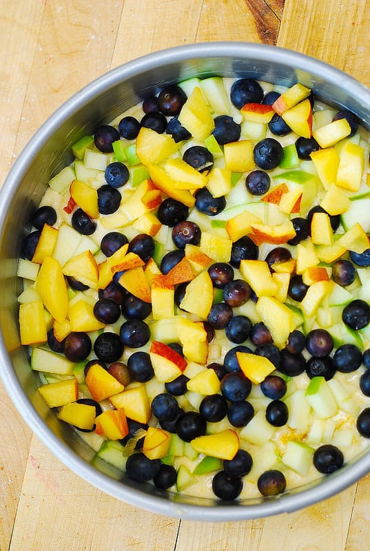 add blueberries, peach, and apples to the springform pan