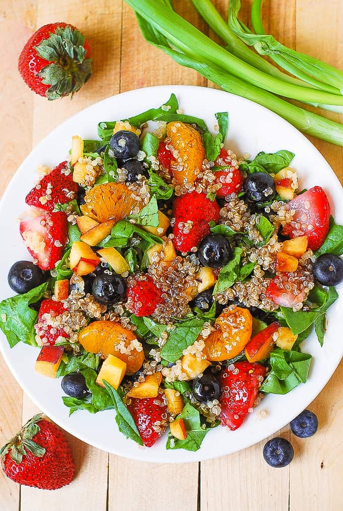 Quinoa salad with spinach, strawberries, blueberries, peaches, mandarin oranges