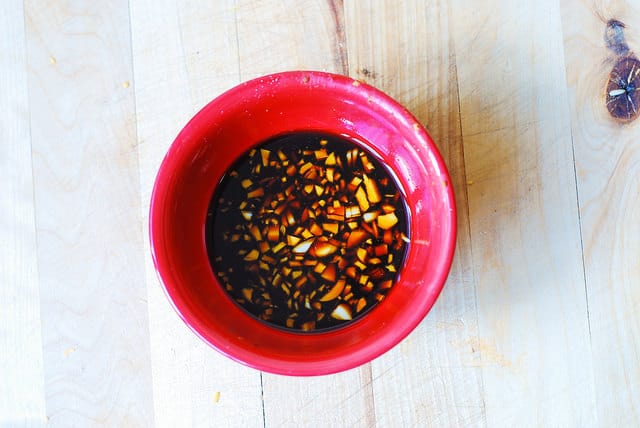 Asian garlic sauce with tamari sauce, brown sugar, ginger, garlic in a red bowl