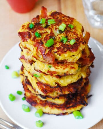 spaghetti squash fritters with bacon - on a white plate.