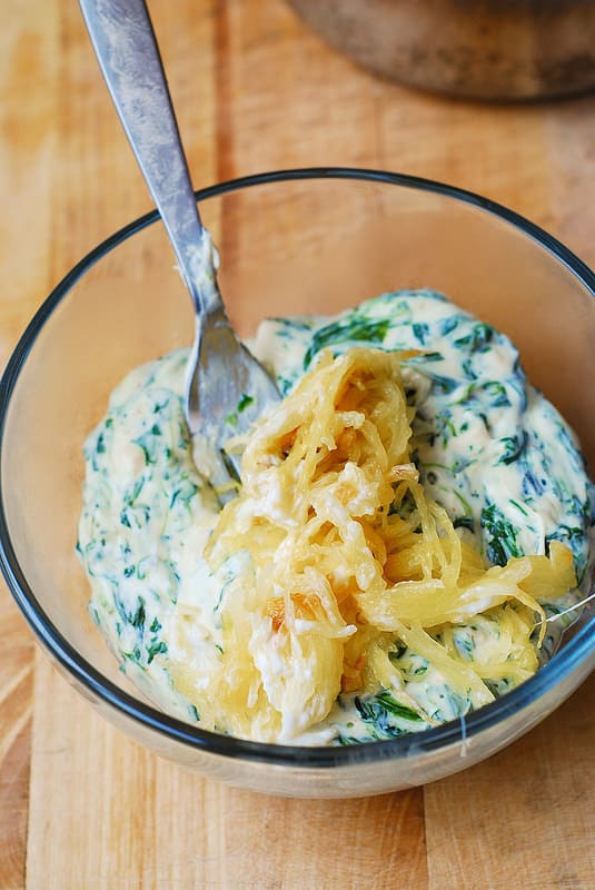 mixing spinach spaghetti squash with cheeses to make the dip (process shot)