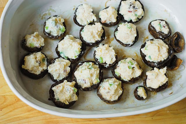 stuffing mushrooms with cheese stuffing (process shot)