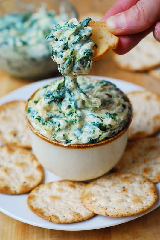 Spinach and Spaghetti Squash Dip in a bowl with the cracker