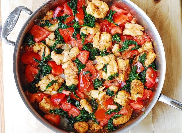 add tomatoes spinach to the garlic shrimp, gluten free recipe, gluten free dinner