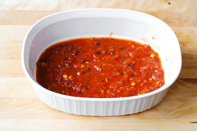 Put salsa on the bottom of the white baking dish