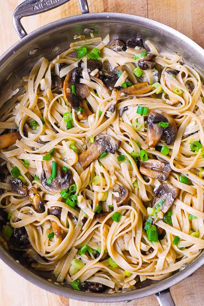 Garlic Mushroom Fettuccine Pasta with Butter, Parmesan Cheese, Green Onions in all-clad large skillet