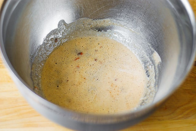 pouring pecan-butter mixture into a separate bowl to cool off (step-by-step photos)