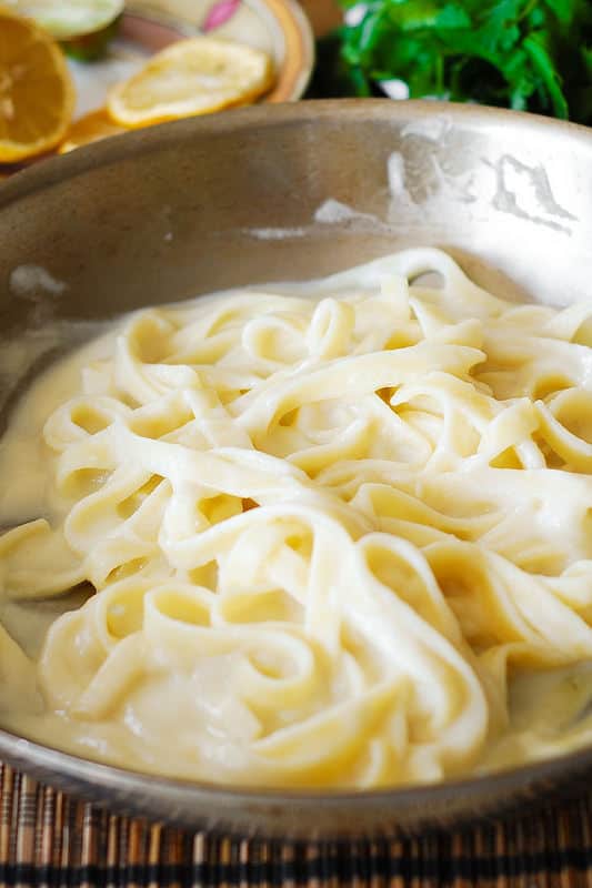 mixing cauliflower sauce with pasta (process shot)