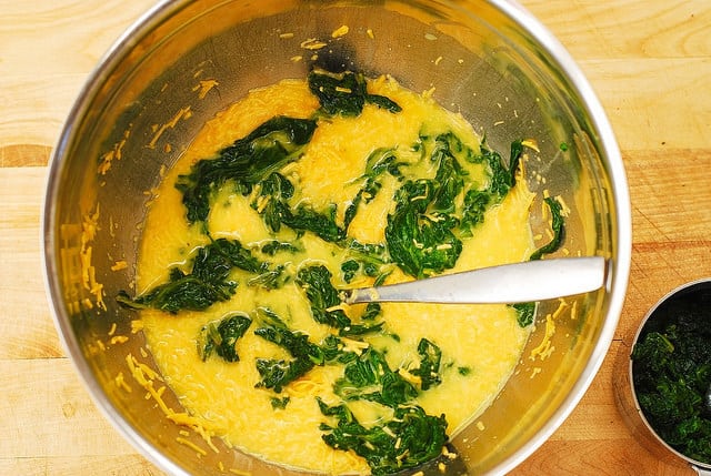 Adding cooked spinach to eggs and cheddar cheese mixture for egg muffins (step-by-step photos)