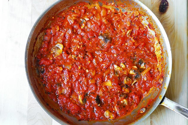 making tomato pasta sauce with mushrooms