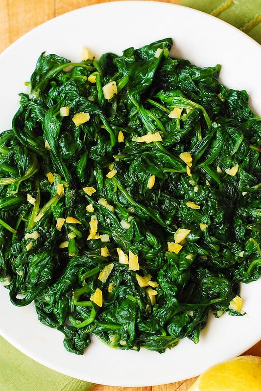 add orange zest over cooked spinach