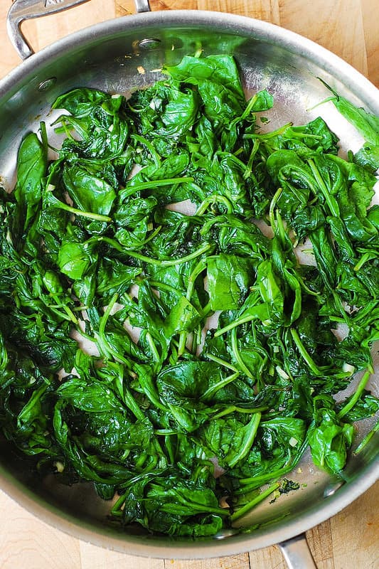 wilted spinach in a large all-clad skillet