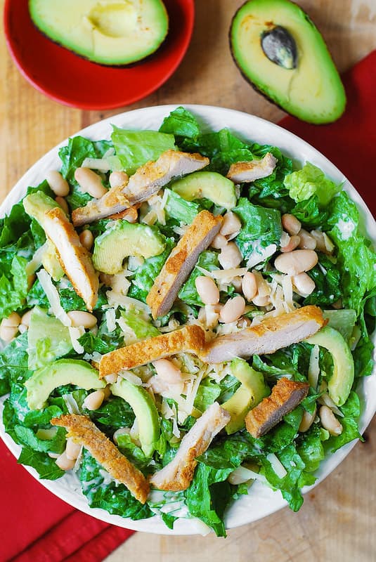 Chicken Caesar Salad with Cannellini Beans and Avocado on a plate