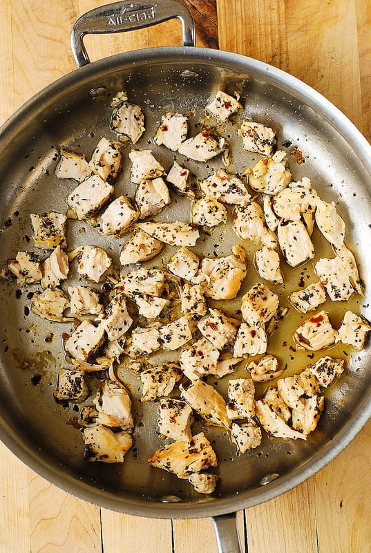 cooking chicken breast in basil and crushed red pepper, then slicing chicken into cubes (step-by-step photos)