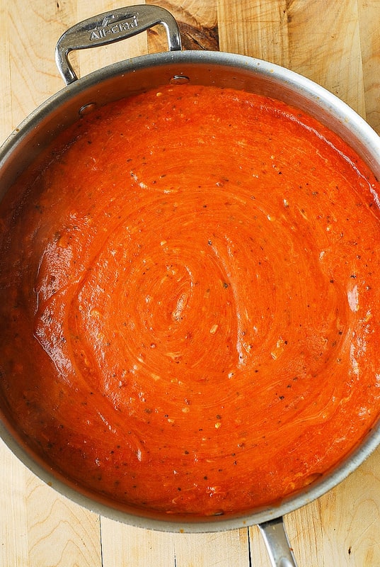 making sauce with tomato sauce and Mozzarella cheese (process shot)
