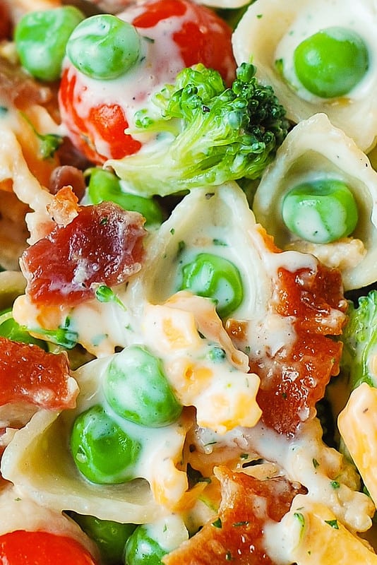Broccoli Bacon Ranch Pasta Salad with cherry tomatoes, sweet peas