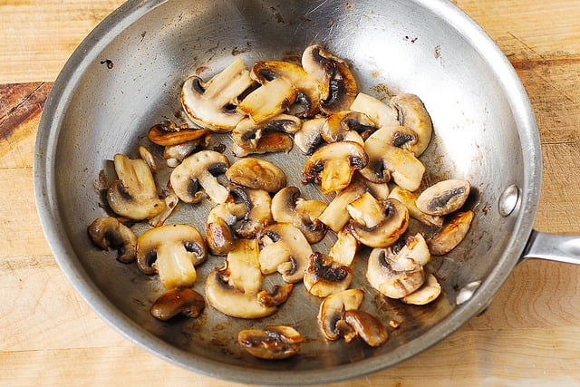 cooked mushrooms in a stainless steel skillet