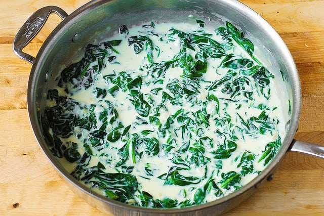 creamed spinach in a stainless steel skillet
