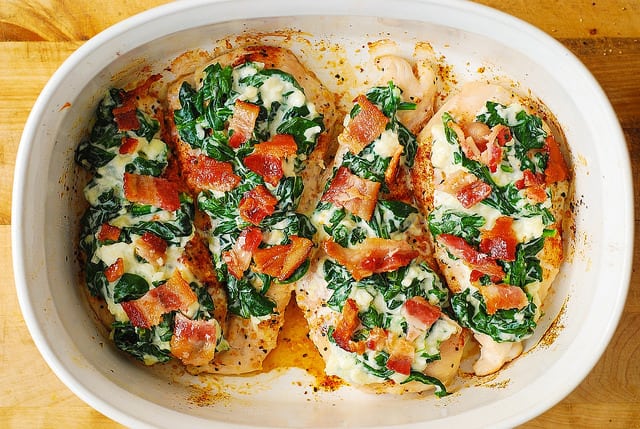 4 chicken breasts topped with creamed spinach, and chopped cooked bacon