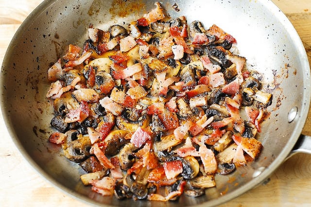cooking bacon and mushrooms in a large skillet