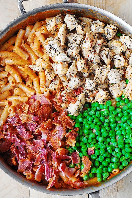 Spicy Chicken Pasta with Bacon and Peas made in a large all-clad skillet
