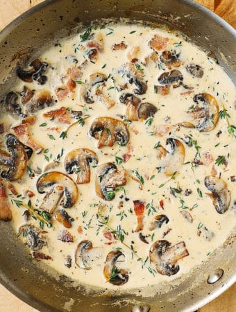 Creamy Mushroom Sauce with Bacon and Thyme - in a stainless steel pan.
